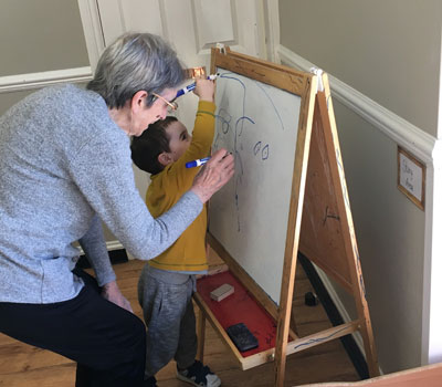 Toddler and elderly resident engaging in activities and joint play