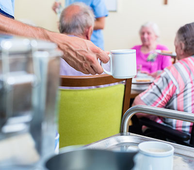 care home staff in action in a lounge