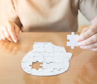 Woman from RCH Care Homes finishing a dementia jigsaw