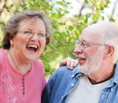 Elderly friends from Orchard Care Homes laughing