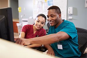 healthcare jobs - two workers look at a screen