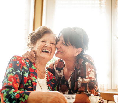 An older lady getting home care from her daughter