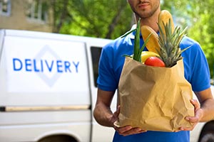 Man delivering groceries to carry on caring 