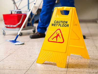 Using wet floor sign while mopping to keep care home insurance valid