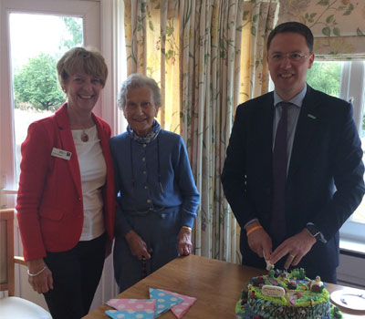 Care home residents and local MP celebrating opening of new eco-garden