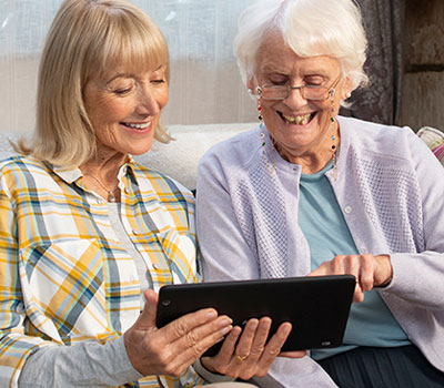 Two people watching a TV advert on a tablet