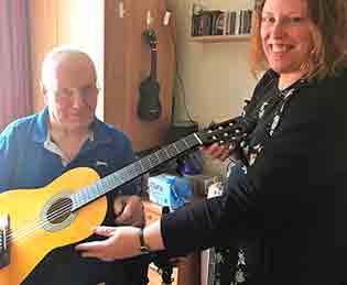 Willowbeck resident playing a guitar