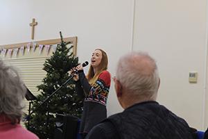 Celia singing to crowd with dementia