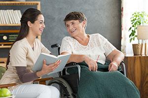 Carer and woman in wheelchair in a care home