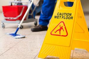 Using wet floor sign while mopping to keep care home insurance valid