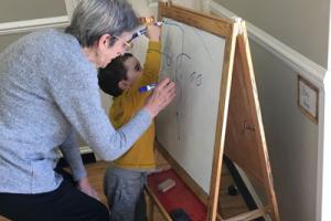 Toddler and elderly resident engaging in activities and joint play