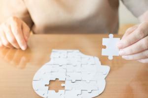 Woman from RCH Care Homes finishing a dementia jigsaw