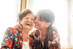 An older lady getting home care from her daughter