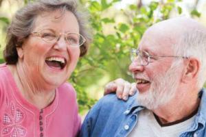 Elderly friends from Orchard Care Homes laughing