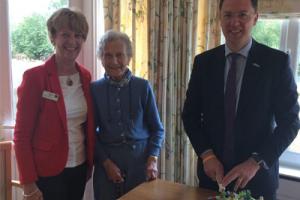 Care home residents and local MP celebrating opening of new eco-garden