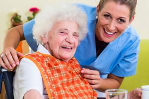 Resident that needs dementia care eating food with carer