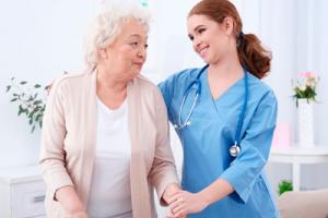 A resident & care home nurse in a bright lighting in a care environment