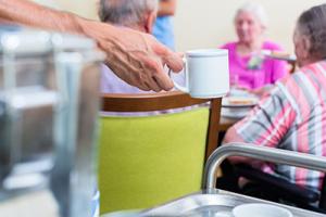 care home staff in action in a lounge